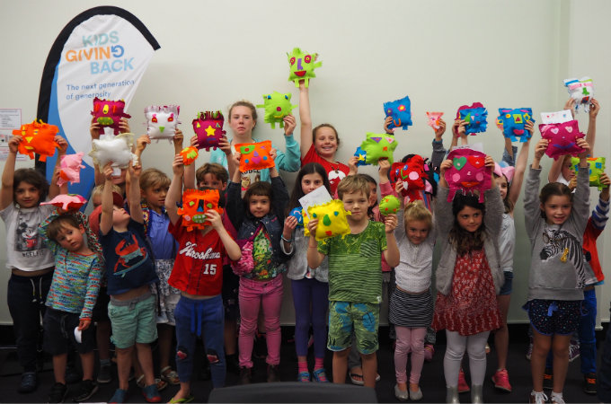 kids sewing softies for kids in a womens shelter
