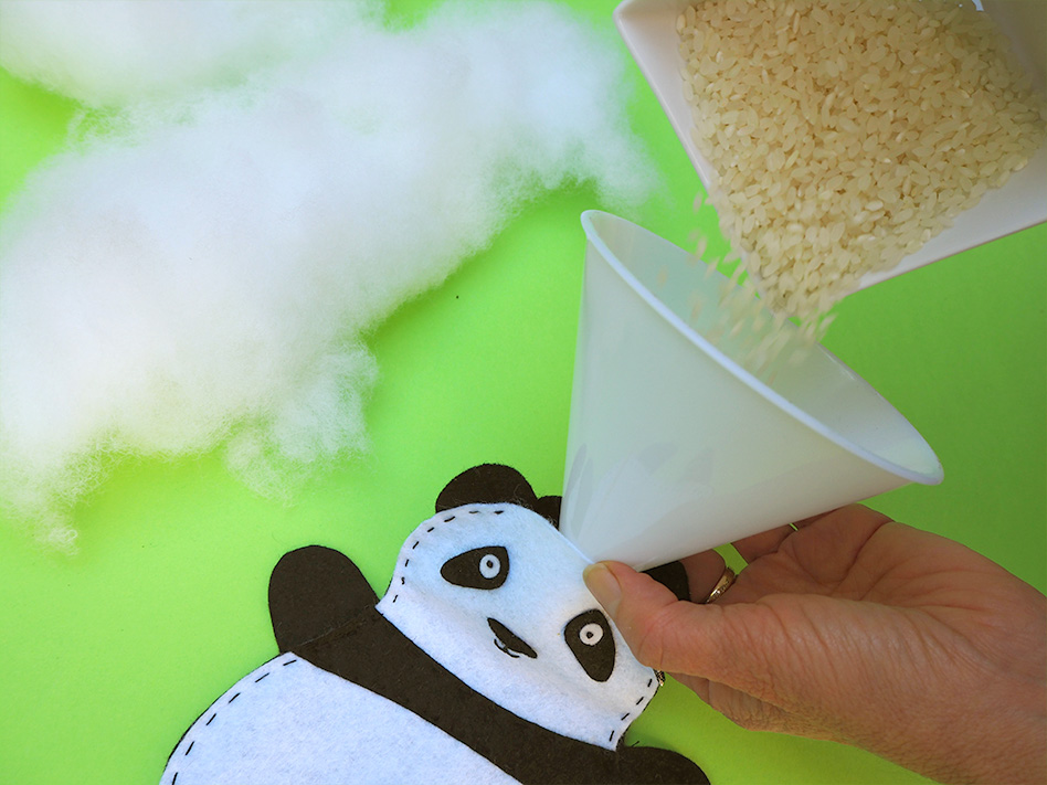 adding a weighting material to a soft toy